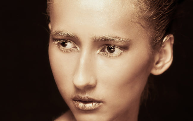 Woman with gold makeup