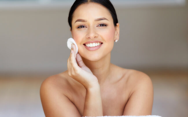 woman cleansing face